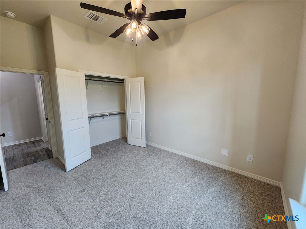 406 Talon Loop Salado, TX 76571 - Photo 17 of 31 an empty room with a ceiling fan and carpet