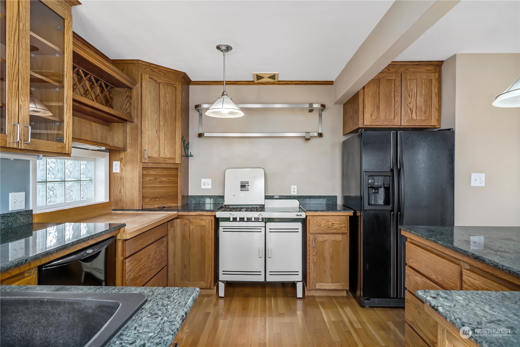 7544 South Sunnycrest Road Seattle, WA 98178 - Photo 23 of 40 a kitchen with stainless steel appliances granite countertop a stove a sink dishwasher and refrigerator with wooden floor