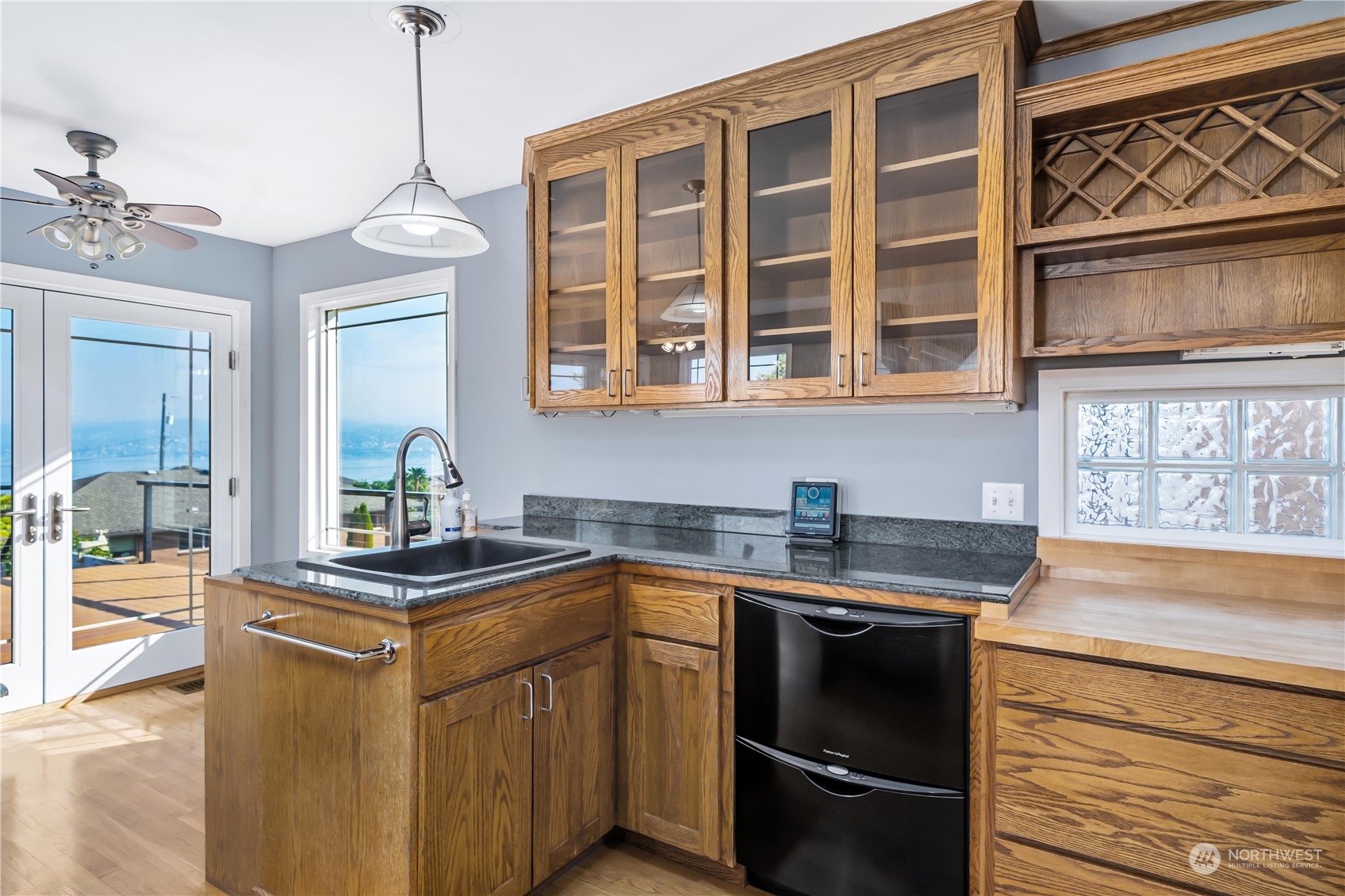 7544 South Sunnycrest Road Seattle, WA 98178 - Photo 24 of 40 a kitchen with stainless steel appliances granite countertop a sink stove and cabinets