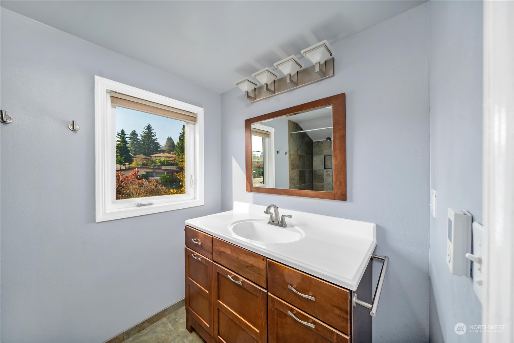7544 South Sunnycrest Road Seattle, WA 98178 - Photo 32 of 40 a bathroom with a sink mirror and vanity