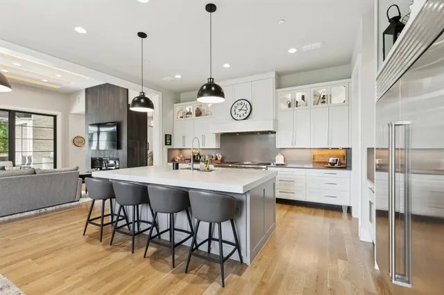 a large kitchen with a table and chairs in it