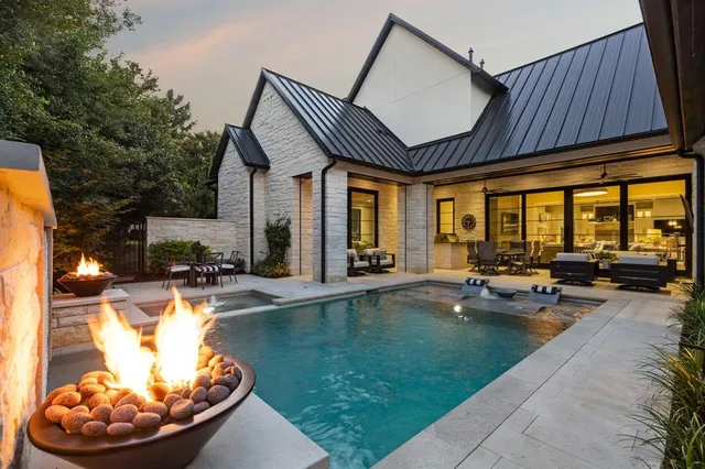 a view of a house with swimming pool and sitting area