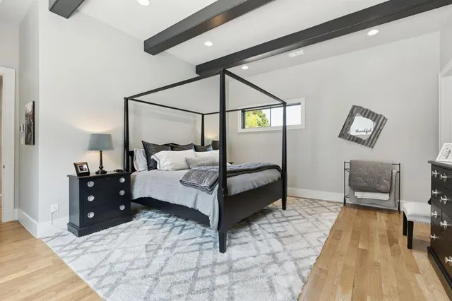 a bedroom with a bed and a table