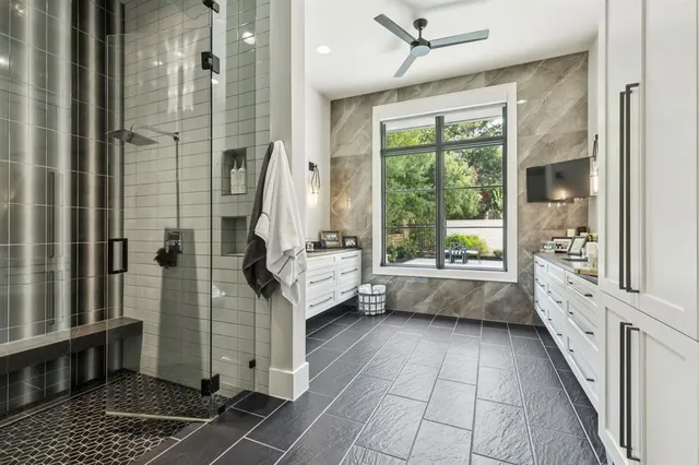 a bathroom with a tub shower and sink