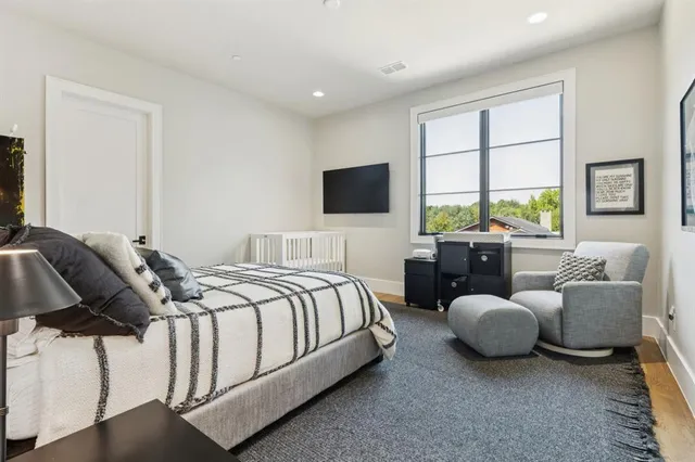 a bedroom with bed couch and window