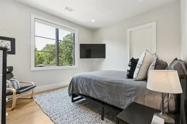 a bedroom with a bed and a window