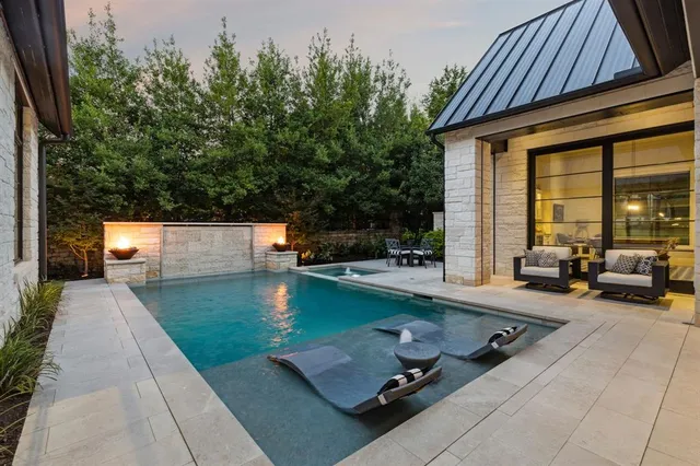 a view of a patio with swimming pool table and chairs