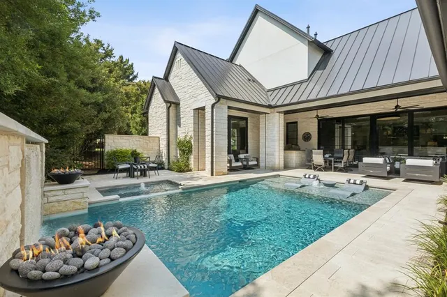 a view of a house with backyard porch and sitting area