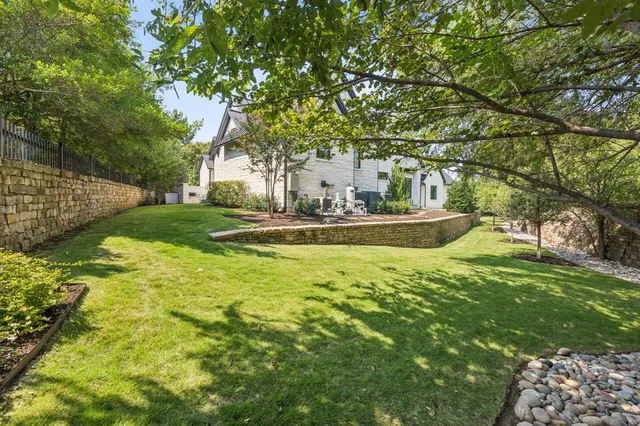 a front view of a house with a yard and trees