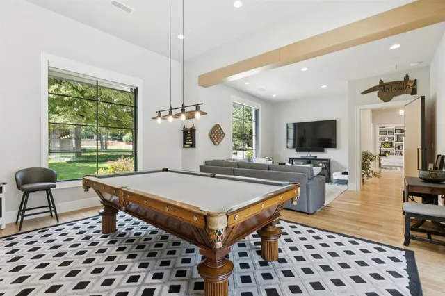 a living room with furniture a flat screen tv and a table