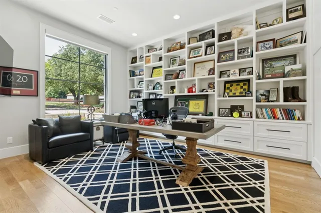 a view of a workspace with furniture and a window