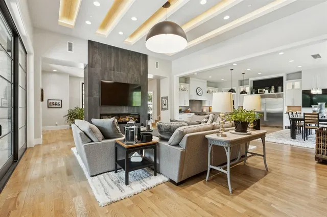a living room with furniture a rug and a flat screen tv