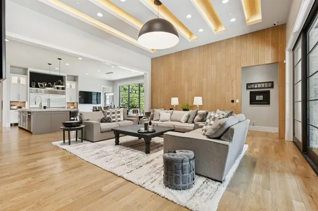 a living room with fireplace furniture and a wooden floor