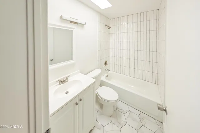 an empty room with wooden floor and window