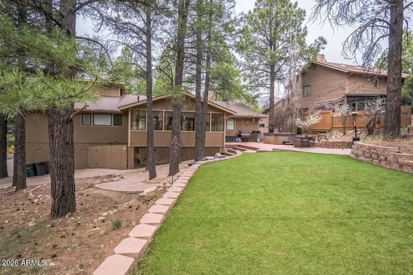 a front view of a house with a garden and sitting area
