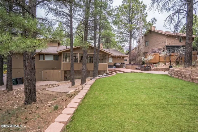 a front view of a house with a garden and sitting area