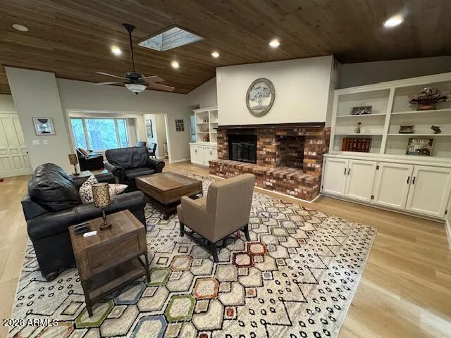 a living room with fireplace furniture and a wooden floor
