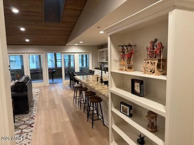 a view of a dining room with furniture a kitchen and chandelier