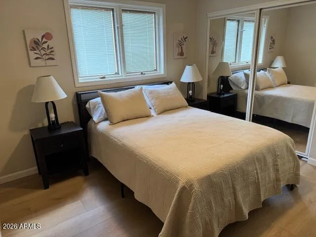 a bed sitting in a bedroom next to a window