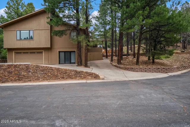 a front view of house with yard and trees