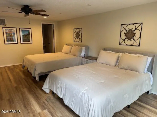 a bedroom with beds and painting on the wall