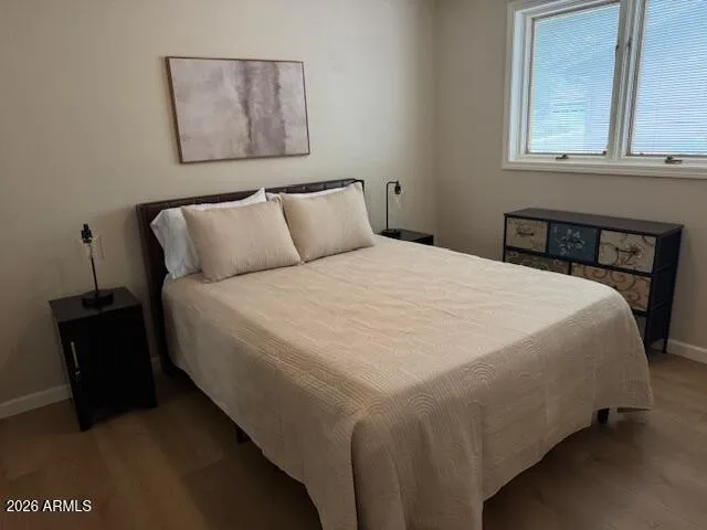 a bed sitting in a bedroom next to a window