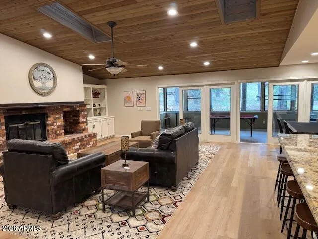 a living room with furniture a large window and stainless steel appliances