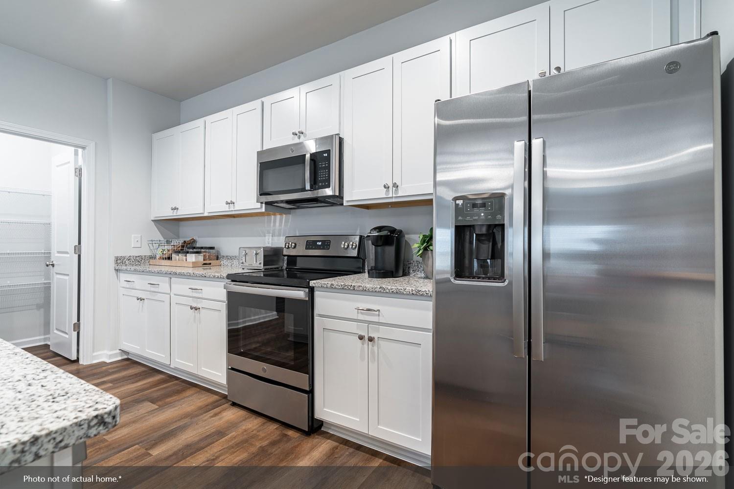 204 Rodeo Drive, Unit 26 Shelby, NC 28150 - Photo 2 of 19 a kitchen with stainless steel appliances granite countertop a refrigerator a stove and a sink with wooden floor