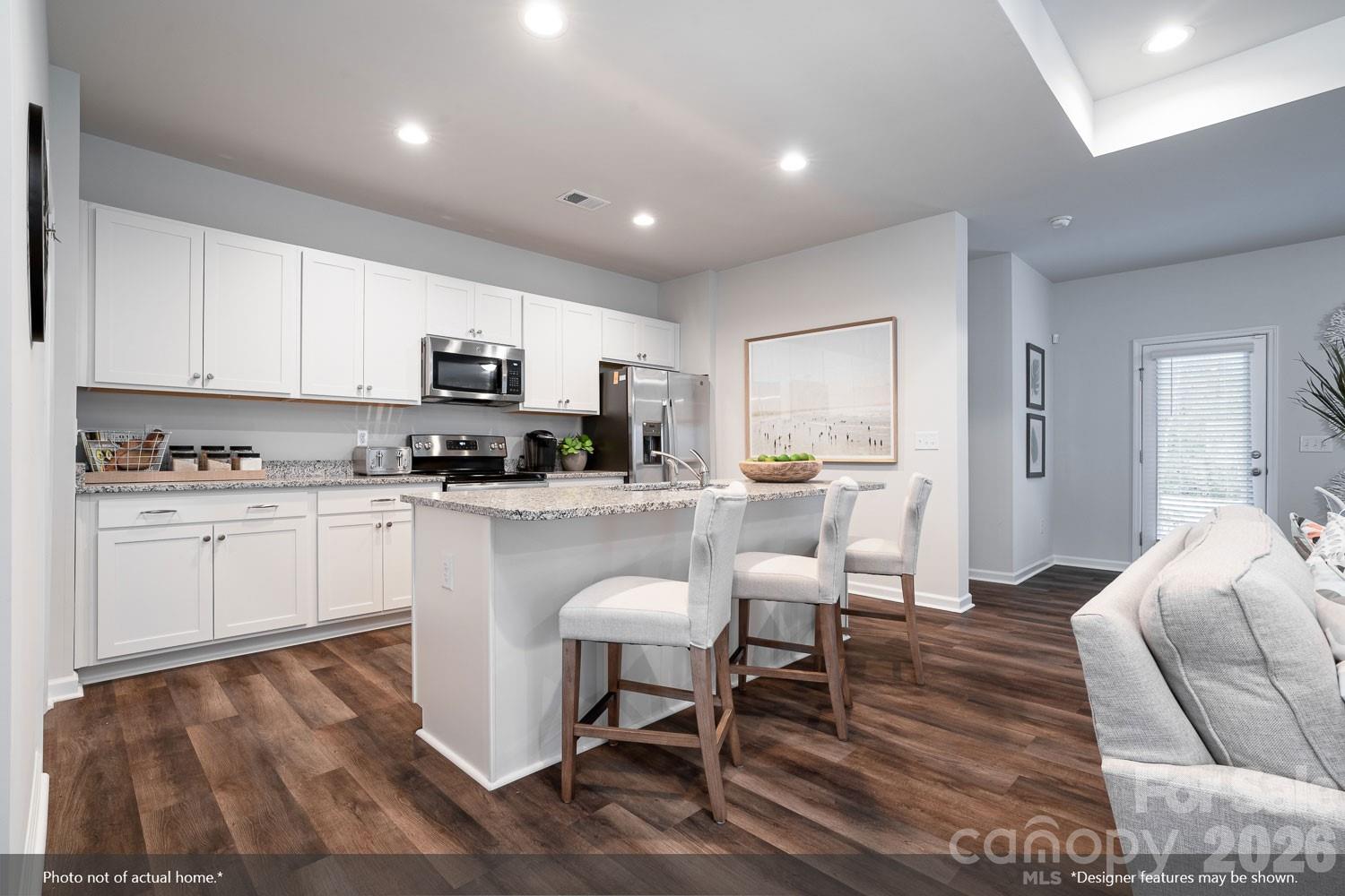 204 Rodeo Drive, Unit 26 Shelby, NC 28150 - Photo 3 of 19 a kitchen with stainless steel appliances granite countertop a stove top oven a sink dishwasher and a refrigerator with wooden floor