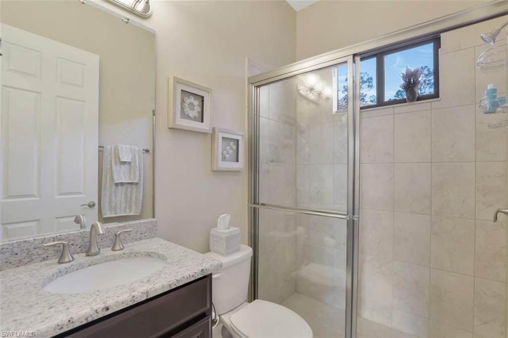 Undisclosed Address Naples, FL 34120 - Photo 18 of 33 a bathroom with a granite countertop sink toilet and shower