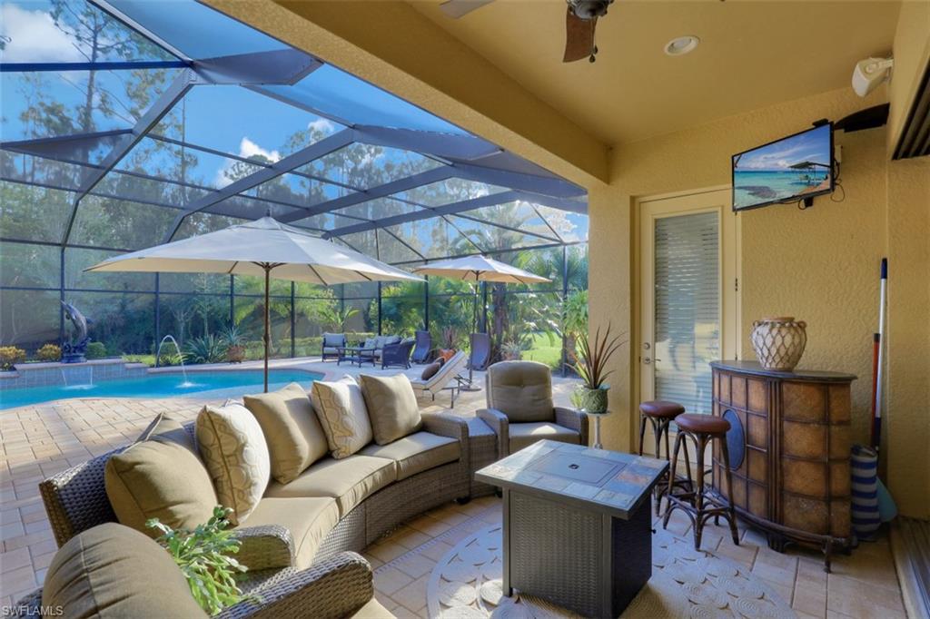 Undisclosed Address Naples, FL 34120 - Photo 19 of 33 a balcony with furniture and a umbrella