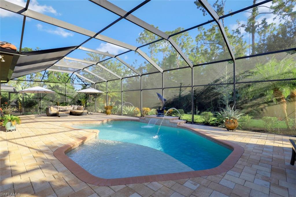 Undisclosed Address Naples, FL 34120 - Photo 20 of 33 a view of a swimming pool with a patio