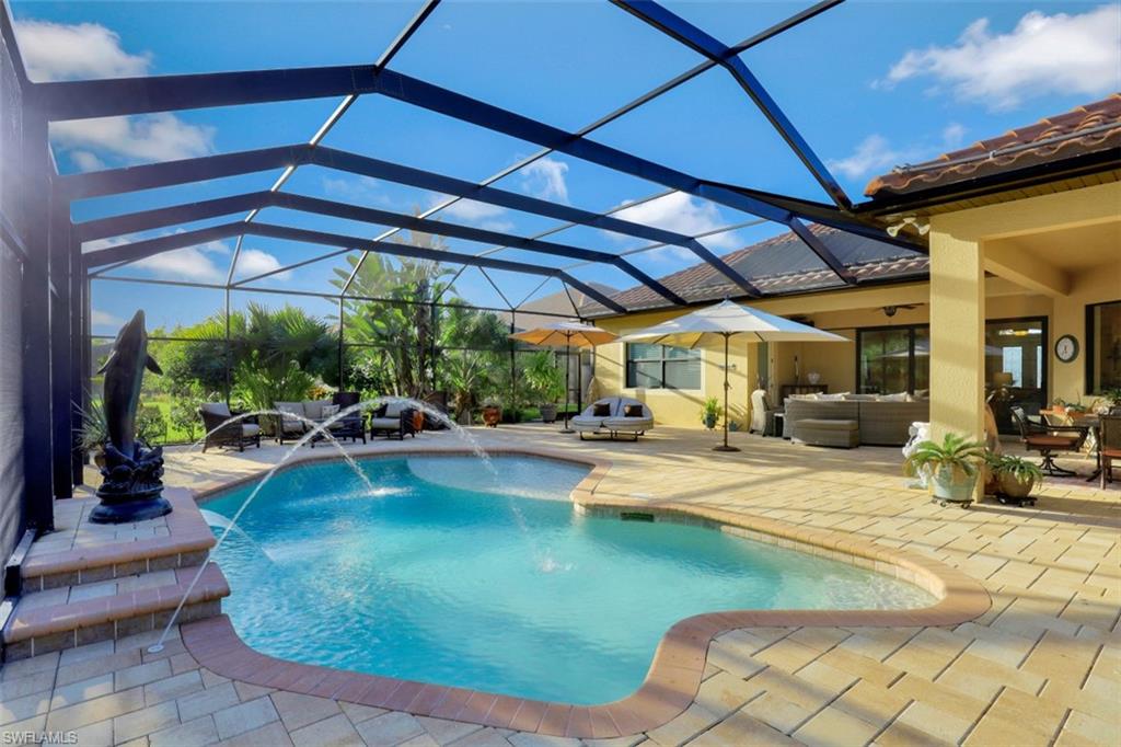 Undisclosed Address Naples, FL 34120 - Photo 2 of 33 a view of a swimming pool with sitting area