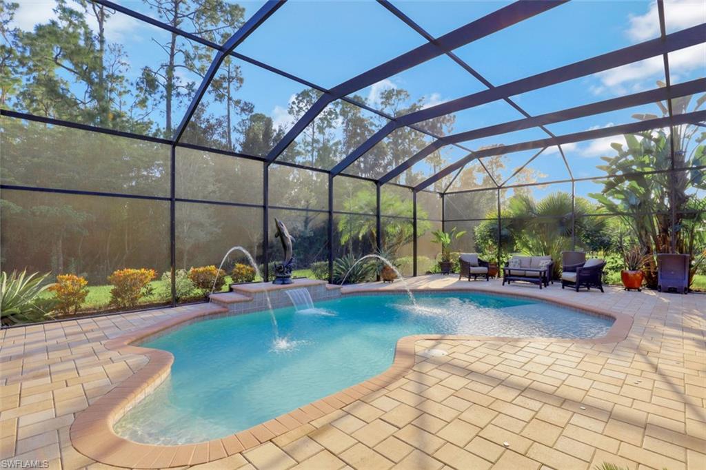 Undisclosed Address Naples, FL 34120 - Photo 22 of 33 a view of a swimming pool with a patio