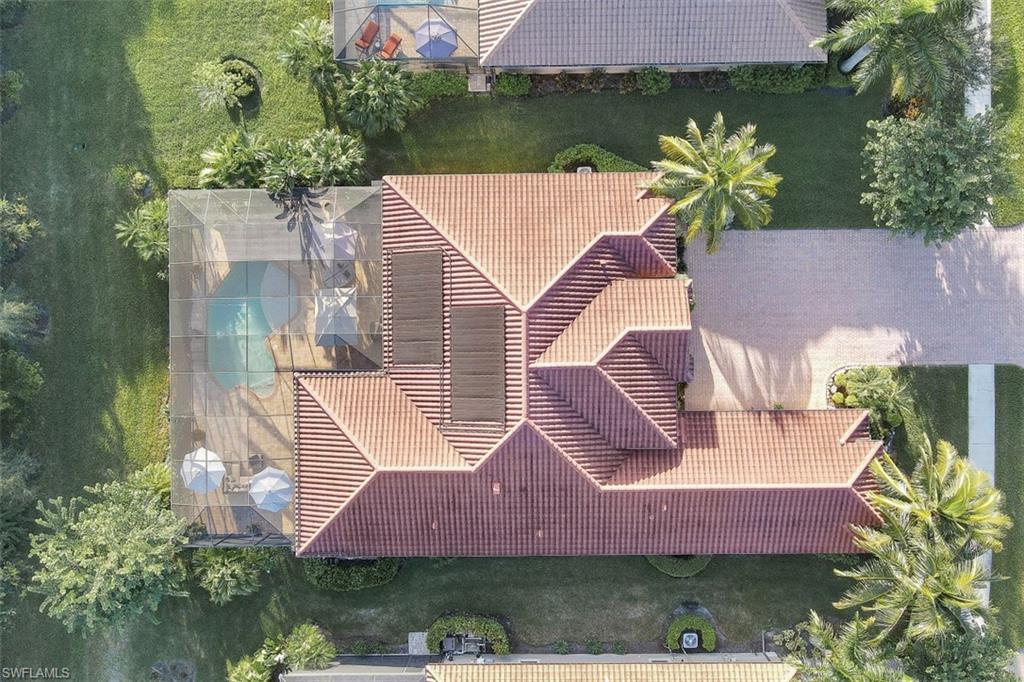 Undisclosed Address Naples, FL 34120 - Photo 27 of 33 an aerial view of house with yard swimming pool and outdoor seating