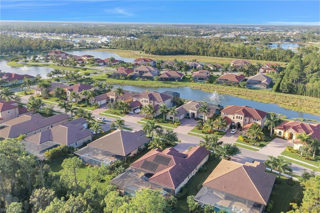Undisclosed Address Naples, FL 34120 - Photo 28 of 33 an aerial view of a city with lots of residential buildings and mountain view in back