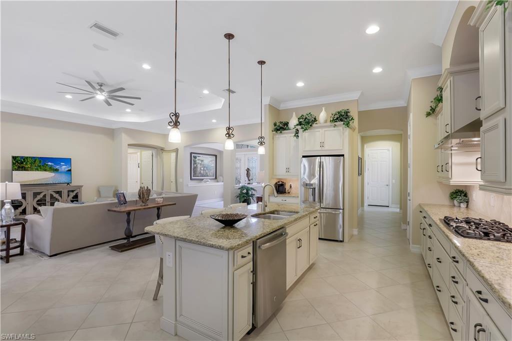 Undisclosed Address Naples, FL 34120 - Photo 3 of 33 a kitchen with counter top space appliances and cabinets
