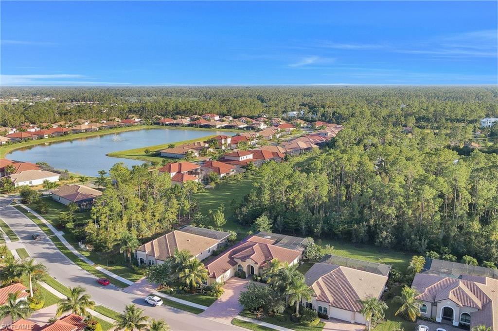 Undisclosed Address Naples, FL 34120 - Photo 9 of 33 an aerial view of residential houses with outdoor space and trees