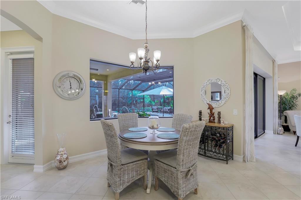 Undisclosed Address Naples, FL 34120 - Photo 10 of 33 a view of a dining room with furniture and a chandelier