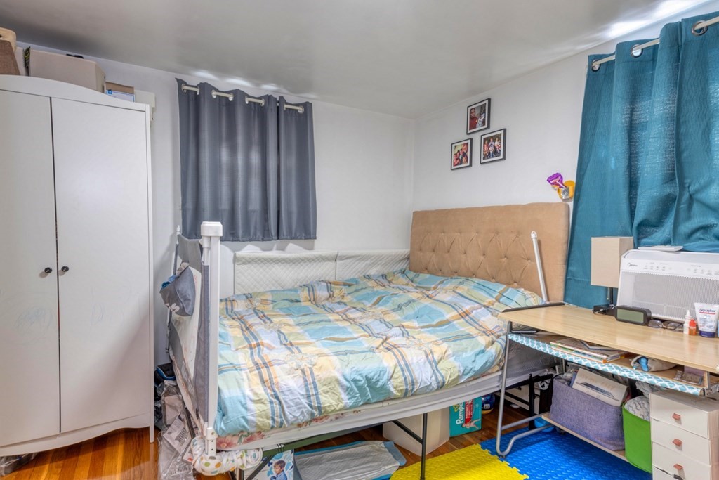 19 Crescent Road Weymouth, MA 02191 - Photo 13 of 24 a bedroom with a bed and a table in it