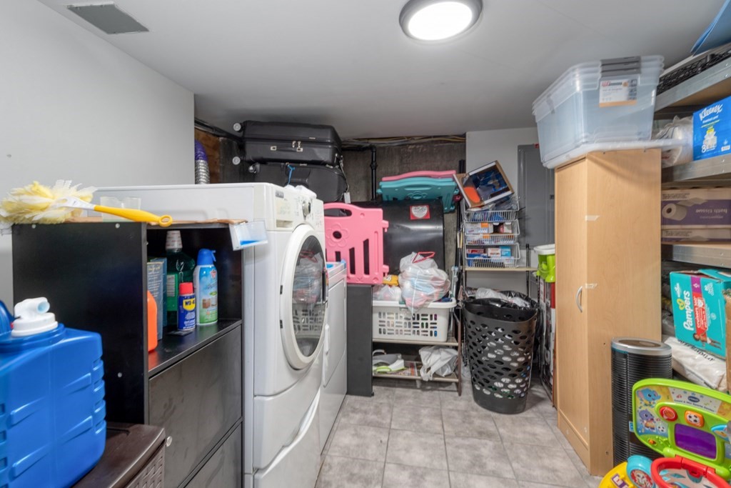 19 Crescent Road Weymouth, MA 02191 - Photo 17 of 24 a utility room with fridge dryer and bicycles