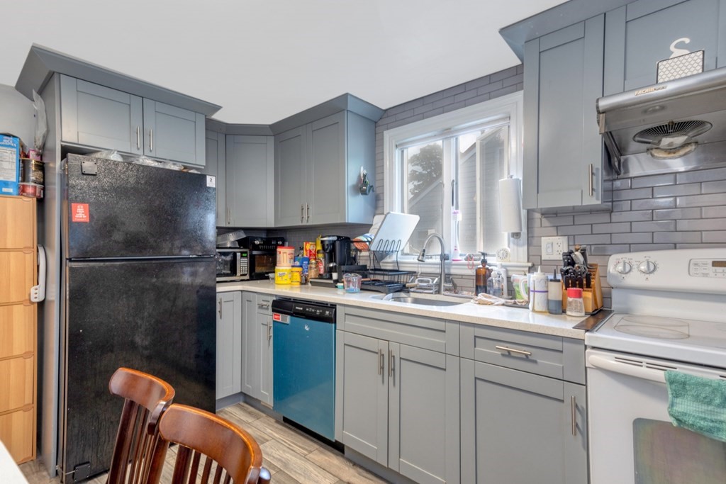 19 Crescent Road Weymouth, MA 02191 - Photo 8 of 24 a kitchen with a sink cabinets and refrigerator