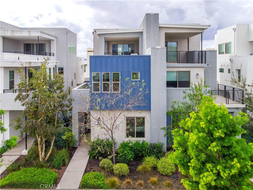 a front view of a multi story residential apartment building with a yard