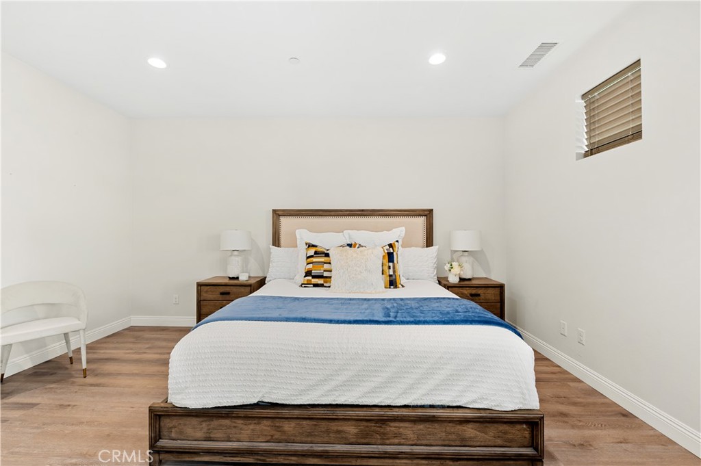 128 Spectacle Irvine, CA 92618 - Photo 14 of 31 a bedroom with a bed and wooden floor