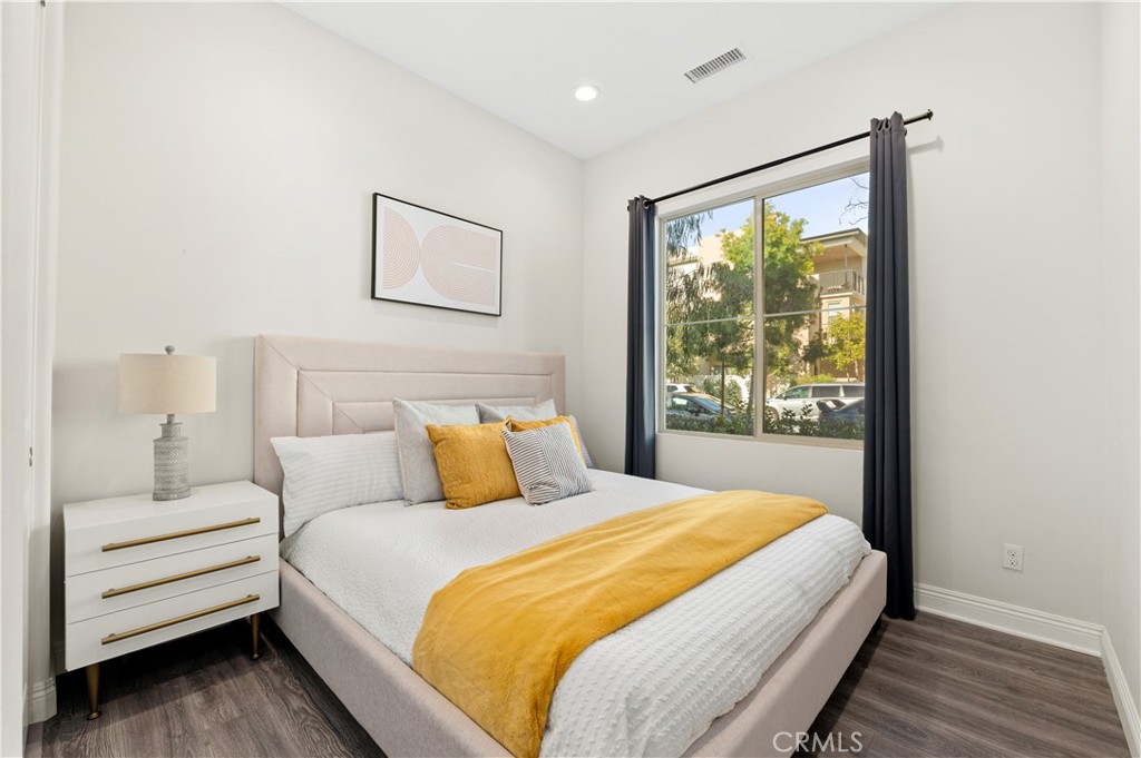 128 Spectacle Irvine, CA 92618 - Photo 7 of 31 a bedroom with a large bed and a window