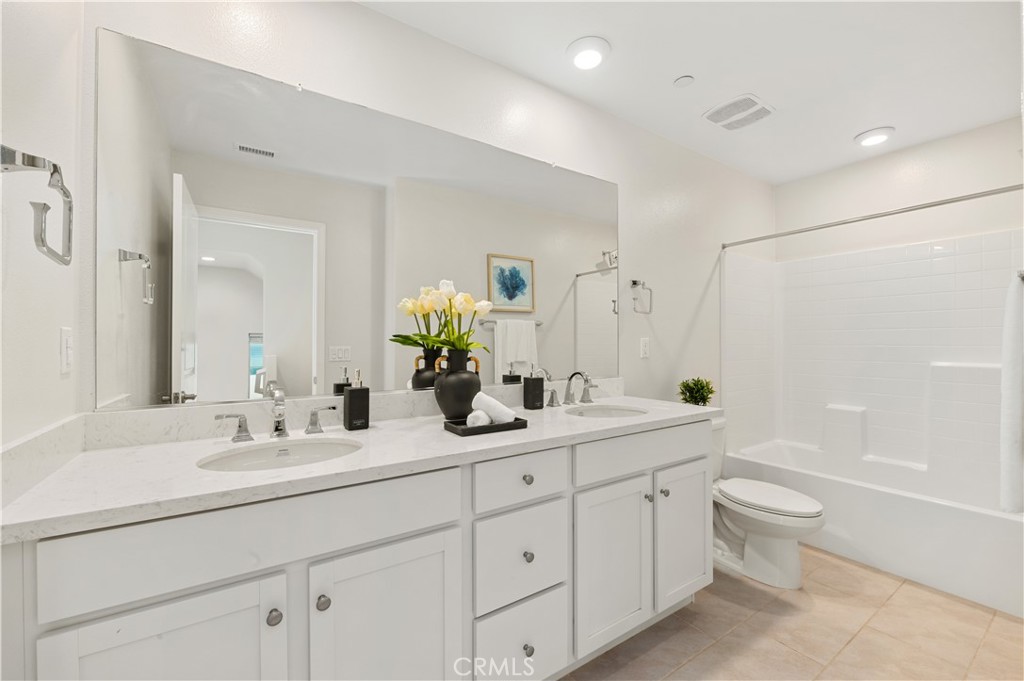 128 Spectacle Irvine, CA 92618 - Photo 10 of 31 a bathroom with a double vanity sink toilet mirror and bathtub