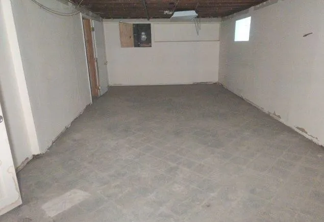 a view of an empty room and wooden floor