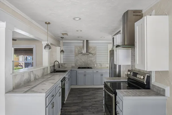 a kitchen with a sink stove and refrigerator