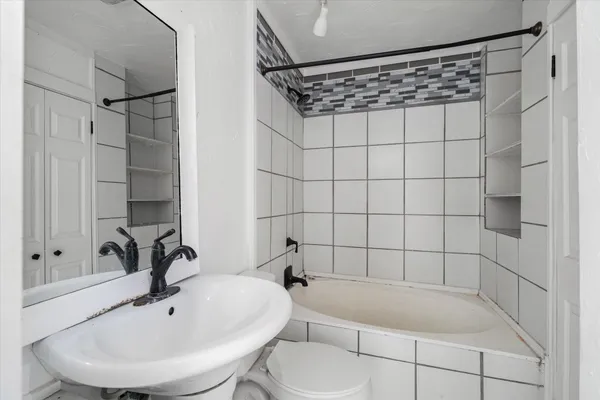 a bathroom with a bathtub and shower