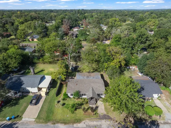 an aerial view of a house with a yard